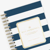 2025 daily monthly from day designer for blue sky featuring a hardcover, navy blue and white stripe design, gold twin wire-o binding in a compact 5x8 planner size.