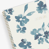 academic weekly monthly planner featuring a white background and blue paint brush florals, twin wire-o binding in a 8.5x11 planner size for the school year 2024-2025 year