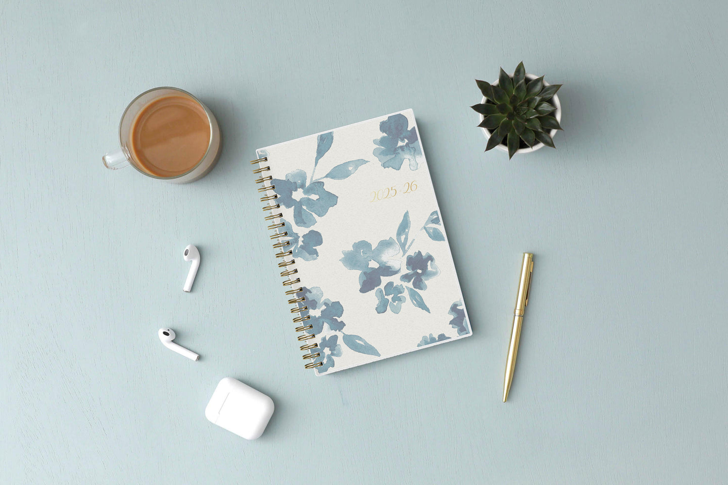 academic weekly monthly planner featuring a white background and blue paint brush florals, twin wire-o binding in a 5x8 planner size for the school year july 2025 - june 2026