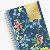 January 2025 - December 2025 weekly monthly planner in 5x8 size from day designer for blue sky with navy background and floral design, and gold twin wire-o binding