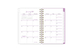 2025 planner featuring a monthly spread with blank writing space, white monthly tabs with purple text
