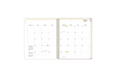 2025 planner featuring a monthly spread with lined writing space, bullet points, and monthly white tabs with gold text.
