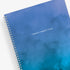 January 2025 to December 2025 weekly planner featuring a solid flexible oceanic ombre front cover, silver twin wire-o, and a 8.5x11 size planner