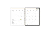 2025 planner featuring a monthly spread with lined writing space, bullet points, and monthly white tabs with gold text.
