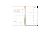 2025 planner featuring a monthly spread with lined writing space, bullet points, and monthly white tabs with gold text.
