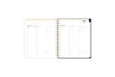 2025 planner featuring a weekly spread with lined writing space, bullet points, and monthly white tabs with gold text.
