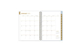 2025 planner featuring a weekly spread with blank writing space and monthly gold tabs with white text.
