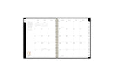 2025 planner featuring a monthly spread with lined writing space, space for bullet points, and monthly white tabs with black text.
