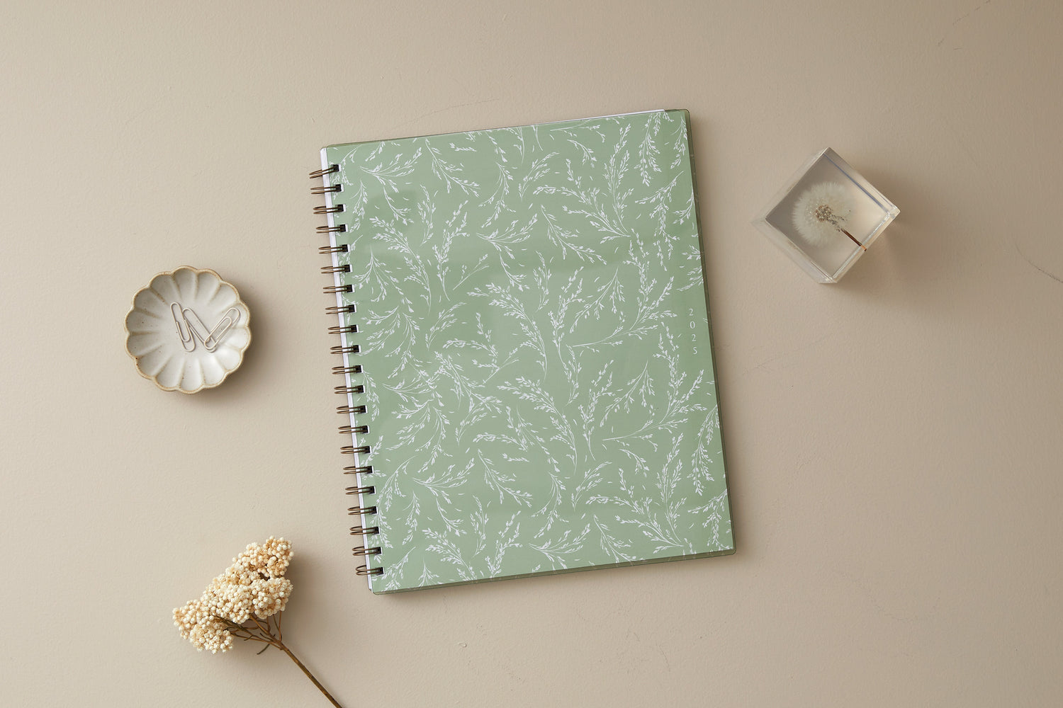 white wisteria floral and light olive green background on this 2025 planner in 8.5x11 size