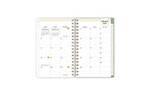 2025 planner featuring a monthly spread with lined writing space, bullet points, and monthly white tabs with gold text.
